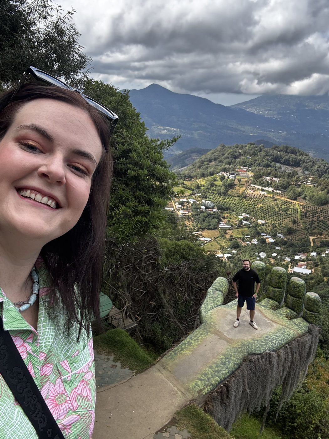 Standing on the Mano Gigante ledge at Hobbitenango, valley view behind